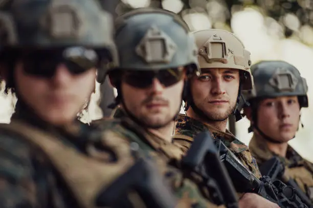 Soldier fighters standing together with ballistic tactical helmets