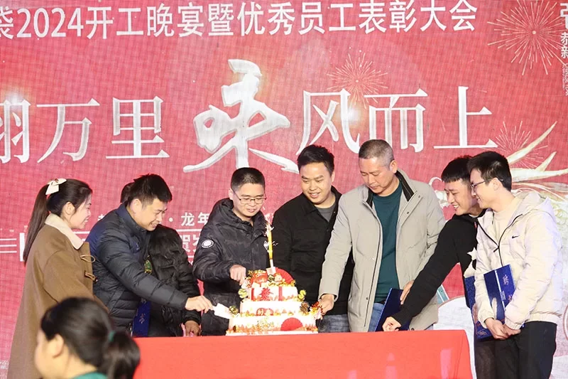 Company executives cutting cake together