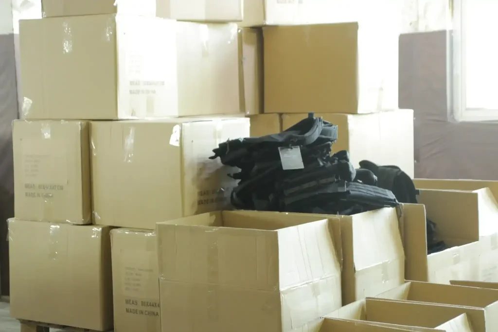 large cardboard boxes with black tactical vests in our warehouse