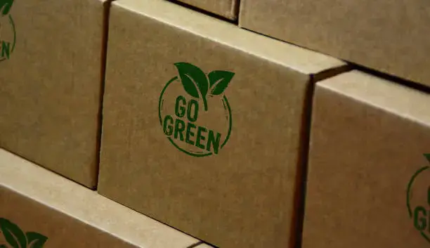 Go green and eco-friendly symbol stamp printed on a cardboard box.