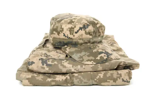 Folded military uniform and cap 