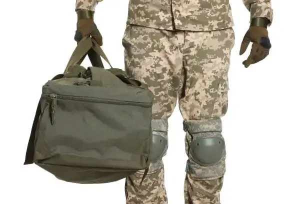 soldier in military uniform with army bag